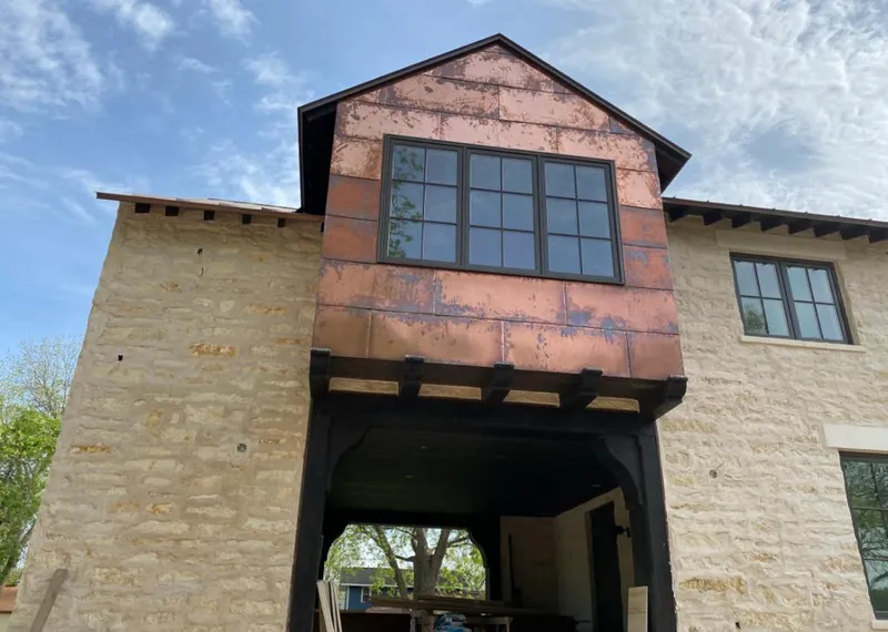 Copper metal panel facade on a stone building for Skylight Installation in Ewa Beach